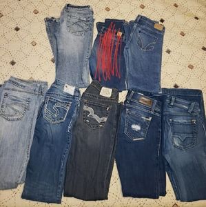 7 pairs of mostly buckle Jean's